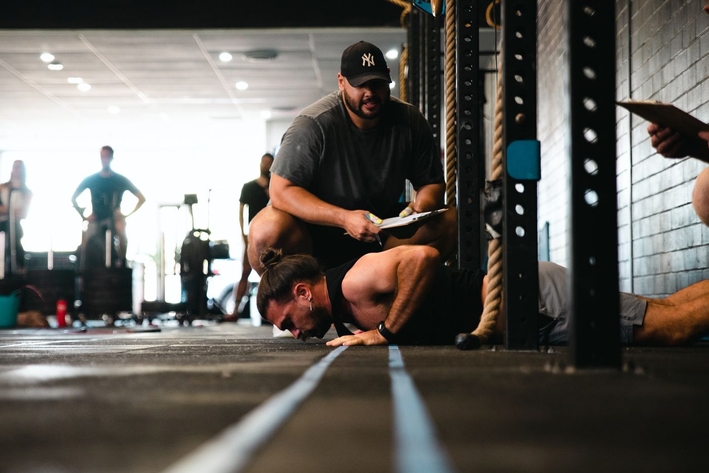 Coach judging a gymnastics movement during a CrossFit class at Grandstand